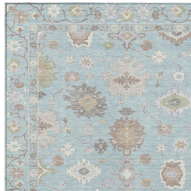 Pattern close-up of sky blue oriental rug with scattered cream, tan, and gray medallions