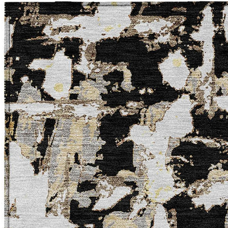 Abstract rug close-up with black and copper blocks and speckles on cream.
