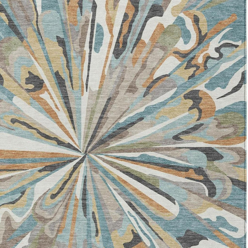 Teal blue abstract area rug with circular center and radiating starburst lines in beige