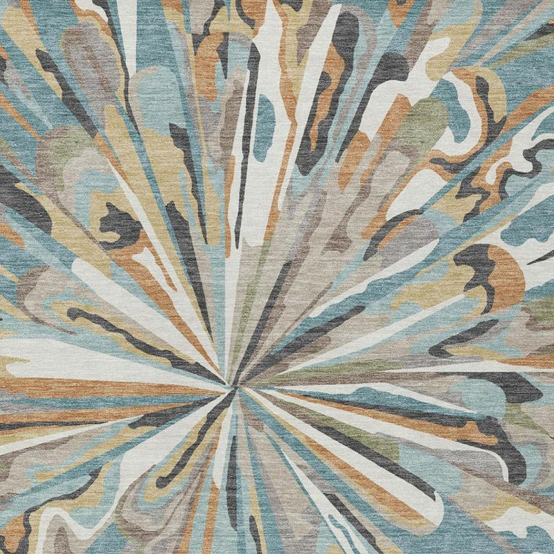 Teal blue and beige abstract area rug close-up featuring a centered burst design