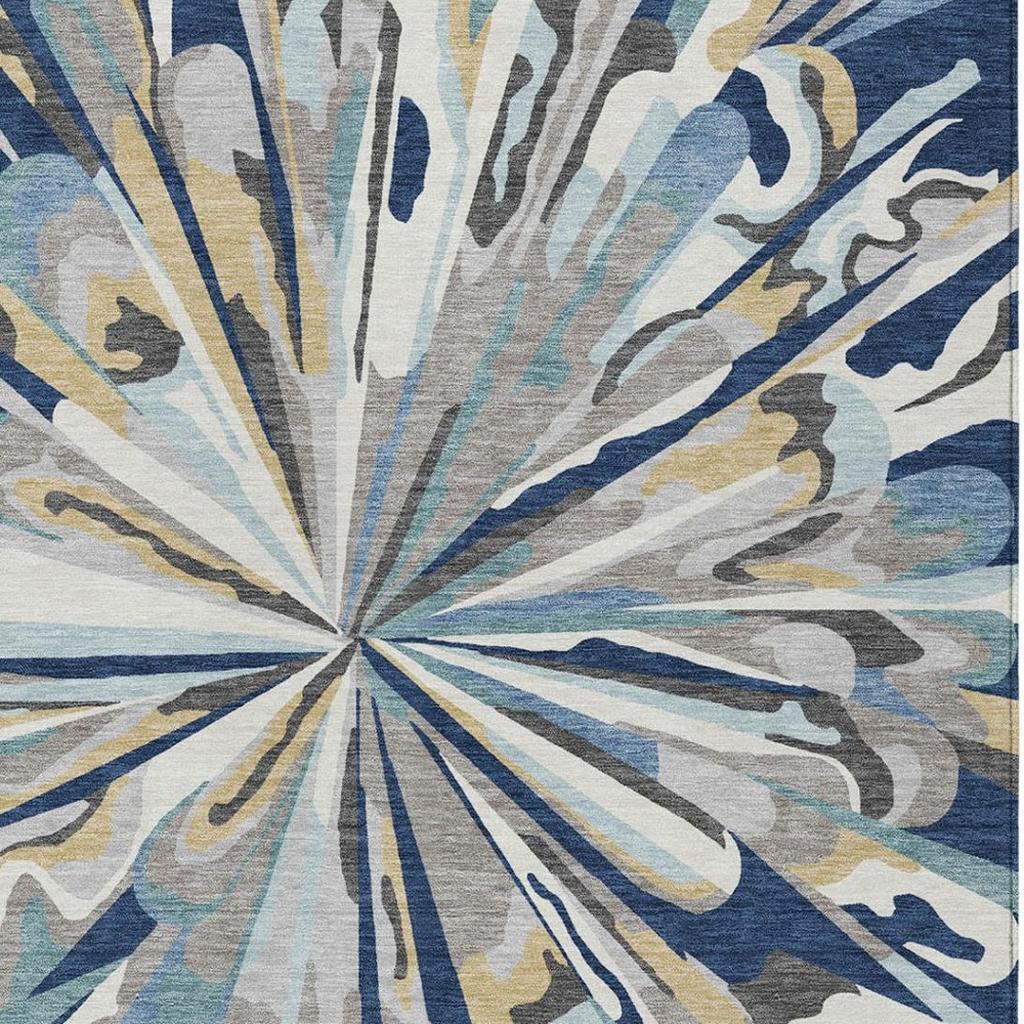Blue and cream abstract sunburst area rug with swirl-like distressed accents