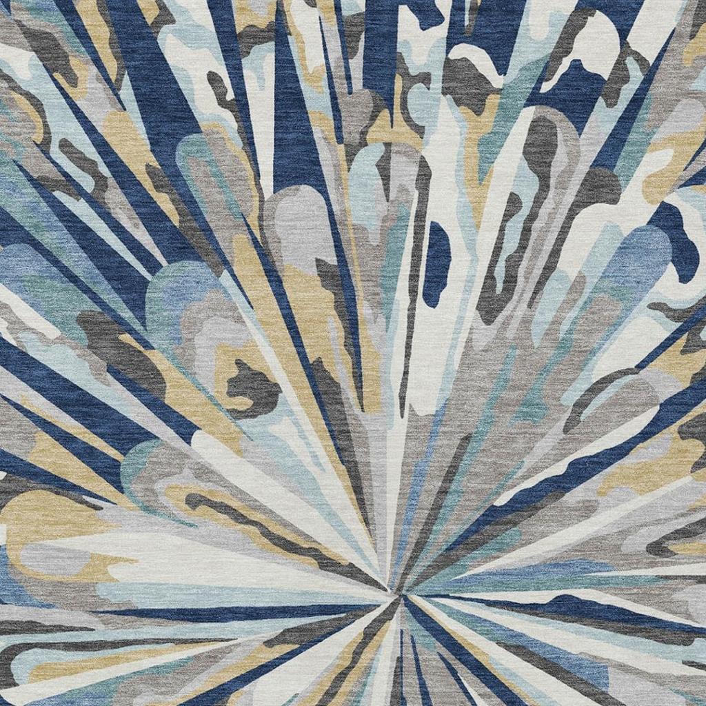 Abstract sunburst area rug in navy, teal, and beige with distressed print