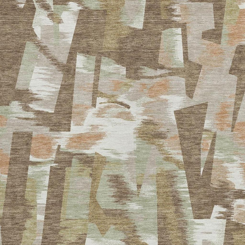 Abstract area rug close-up showing brown, beige, and light greenish geometric blocks.