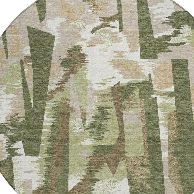 Tight view of round abstract area rug showing layered olive, sage, and cream block design