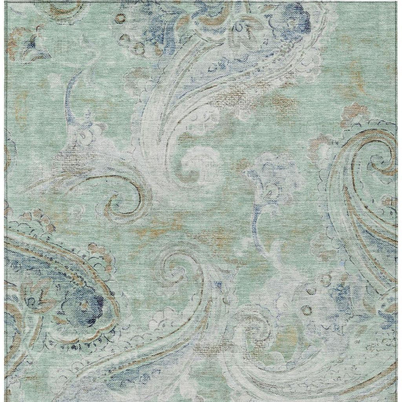 Close-up of aqua and teal paisley area rug texture with faded swirls