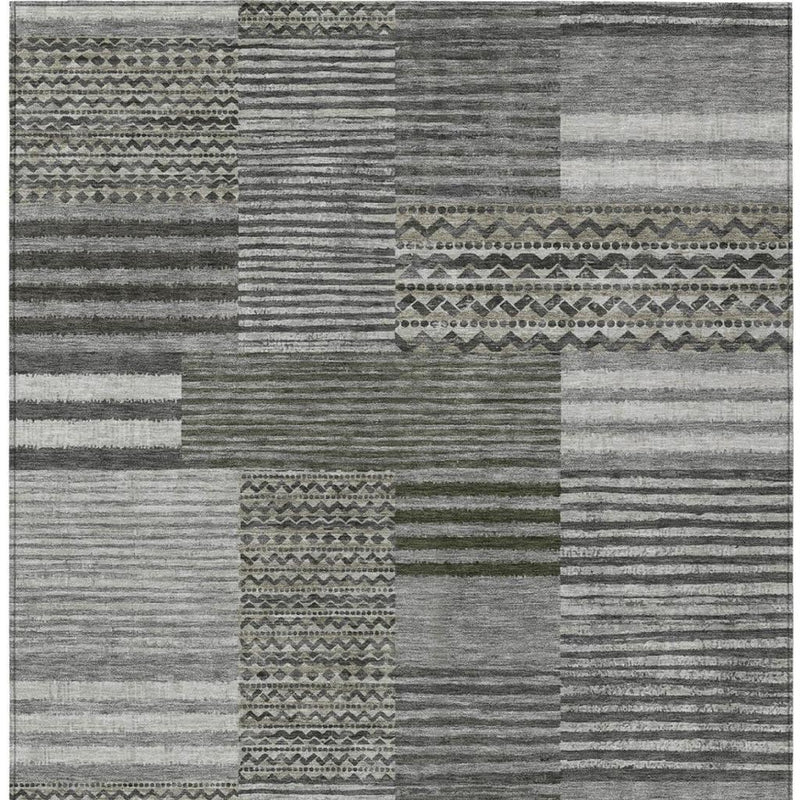 Pewter and gray patchwork area rug with striped blocks and geometric border