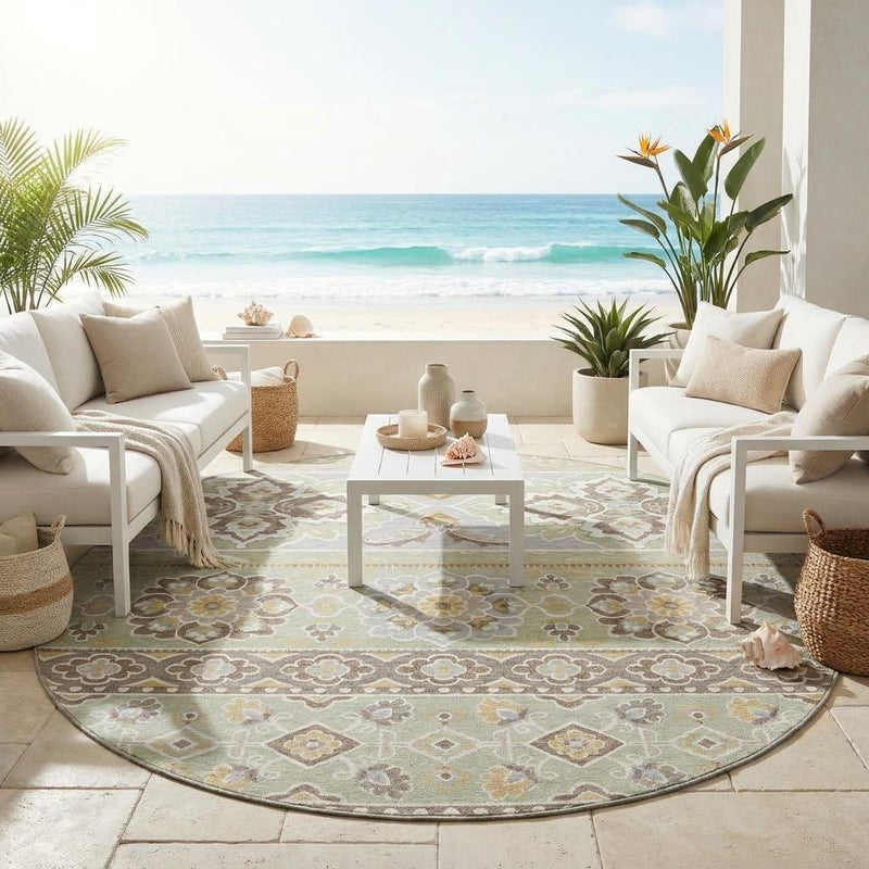 Round green and ivory tribal floral area rug on patio floor beneath outdoor seating