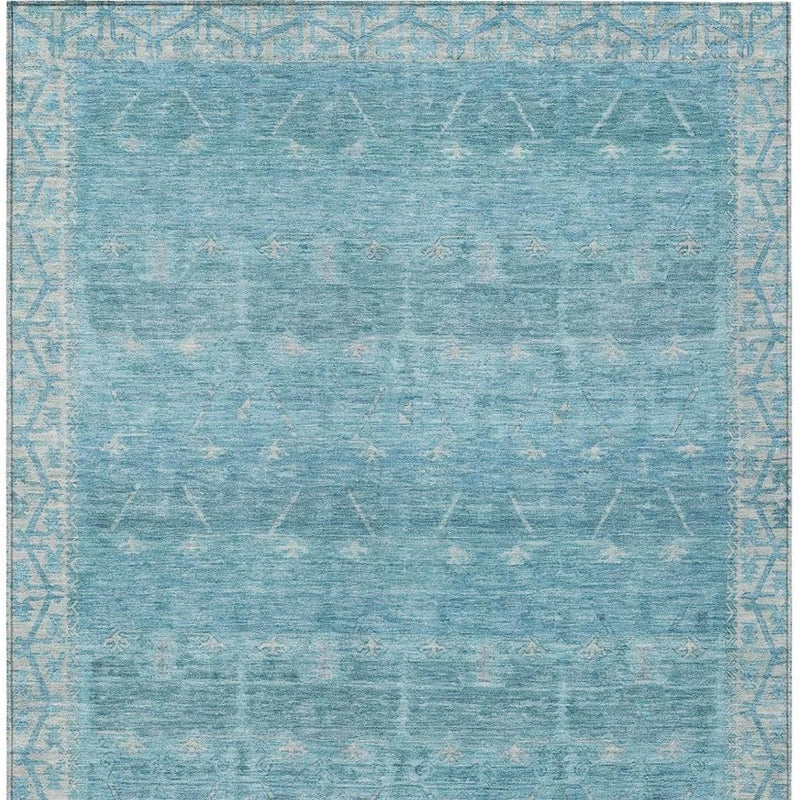 Blue and teal tribal area rug, distressed pattern with light geometric motifs across field.