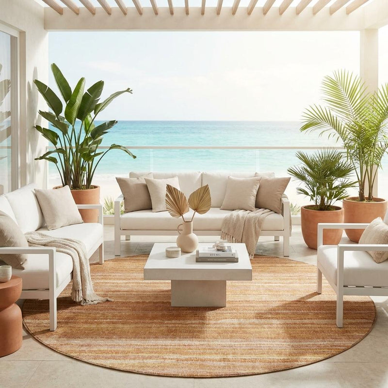 Round striped area rug with orange and copper bands and a cream base in living space