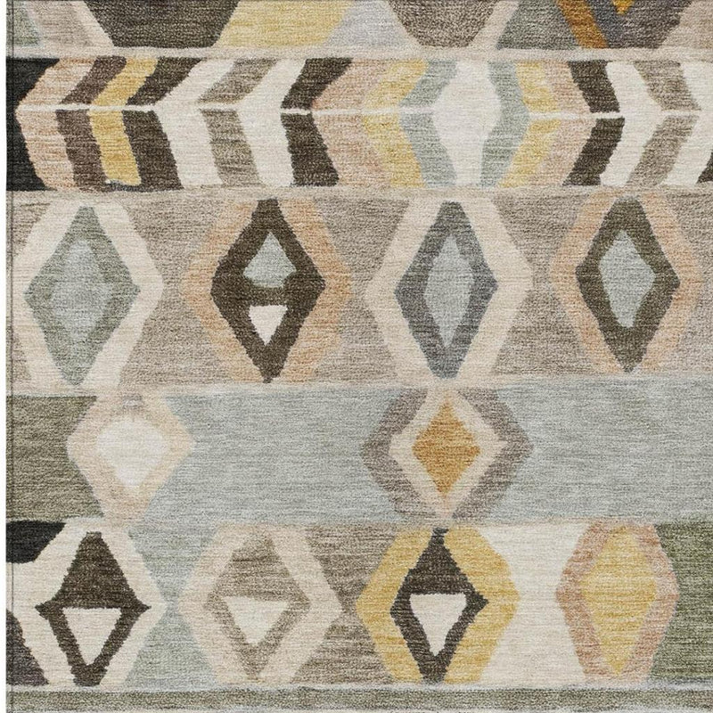 Close-up of tribal area rug fabric with gray, cream, olive, and yellow geometric shapes