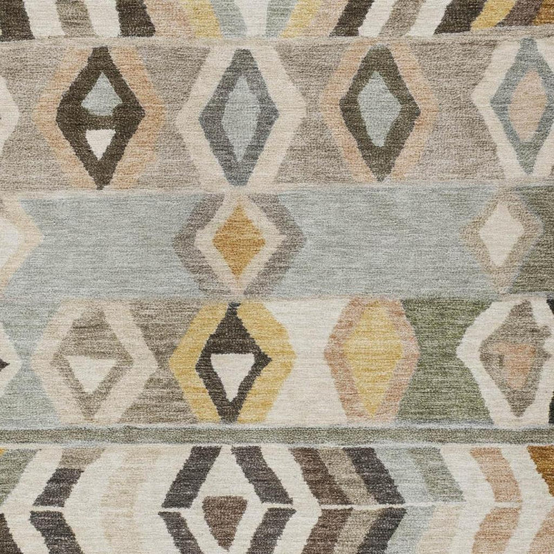 Close-up of gray tribal rug showing diamond and arrow patterns in tan, black, and yellow