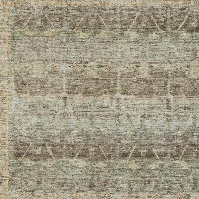 Textured area rug with faded tribal design, off-white beige with gray-green and brown hints.
