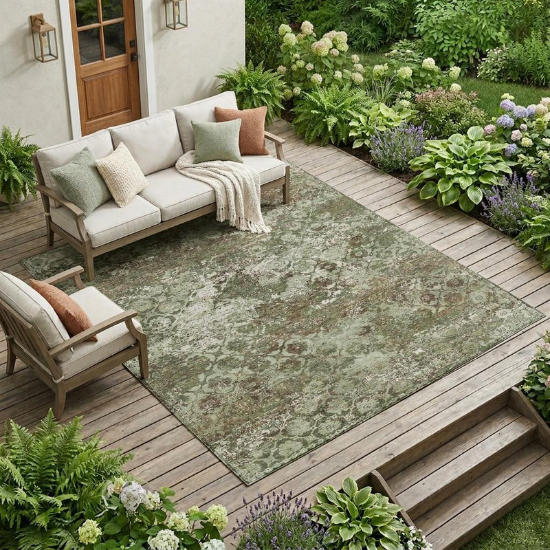 Olive green floral medallion area rug with distressed pattern, laid flat for indoor/outdoor.