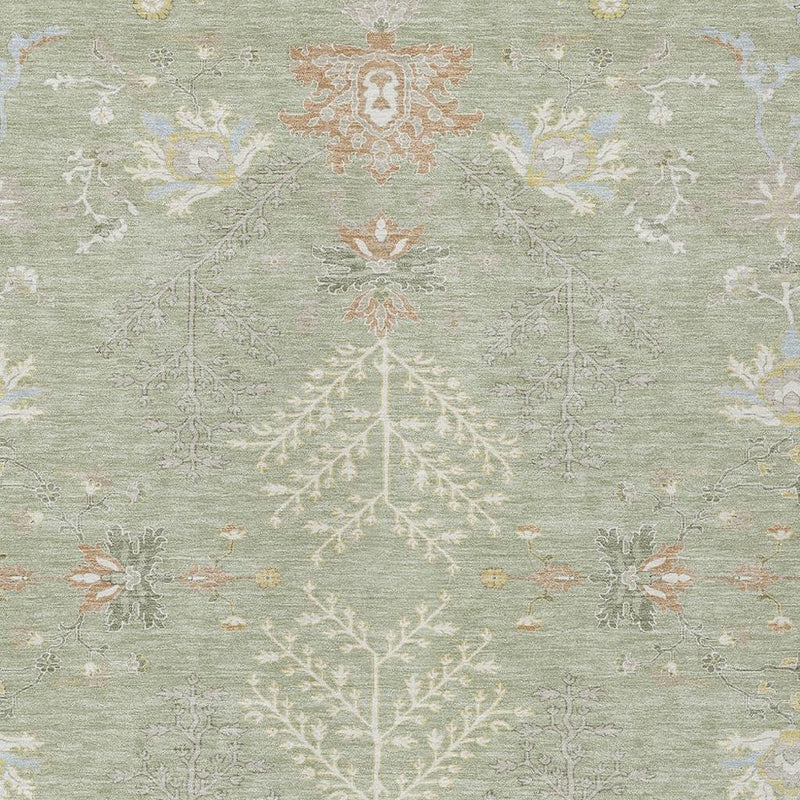 Top view close-up of green area rug with symmetrical ivory tree-like pattern