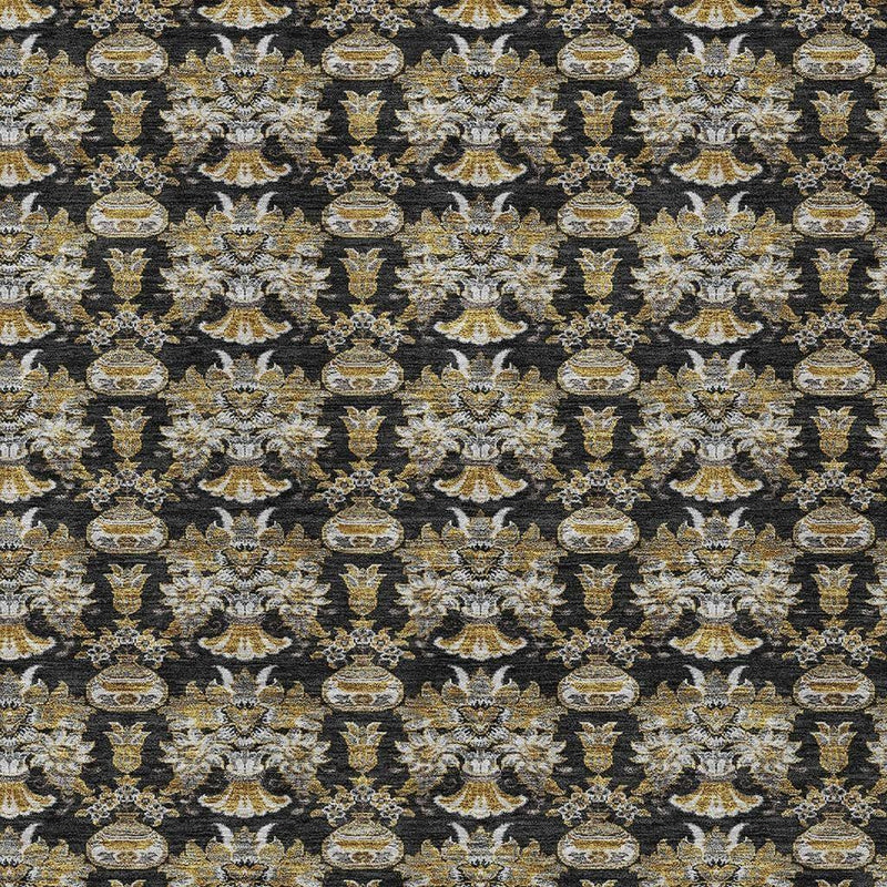 Pattern detail of black rug with gold and cream floral medallions and scrollwork