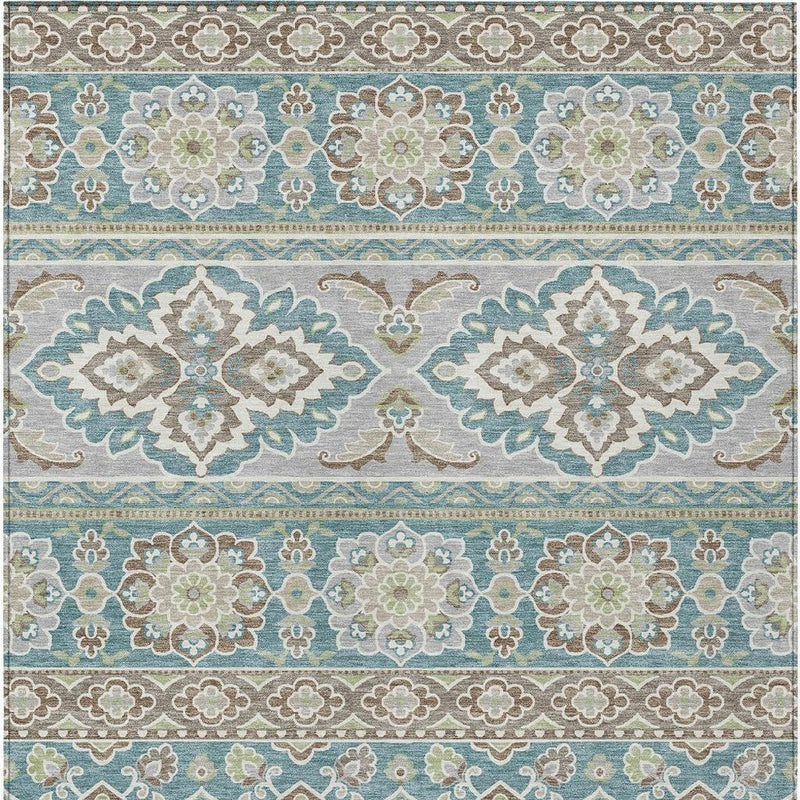 Teal and green tribal area rug close-up with central medallion and decorative border