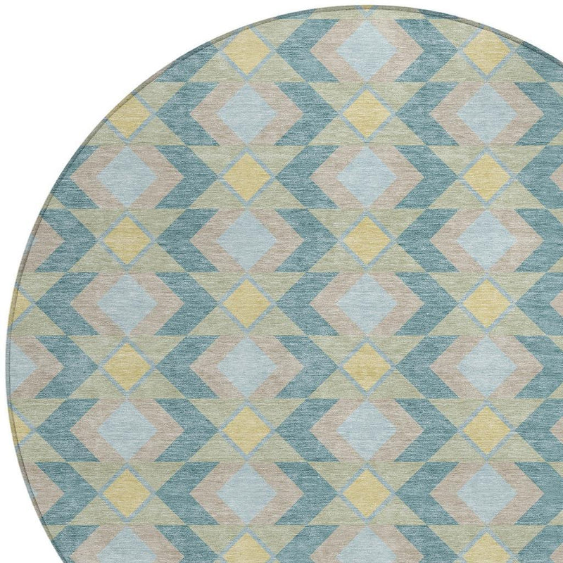Round area rug close-up with light blue, yellow, and beige geometric diamond pattern