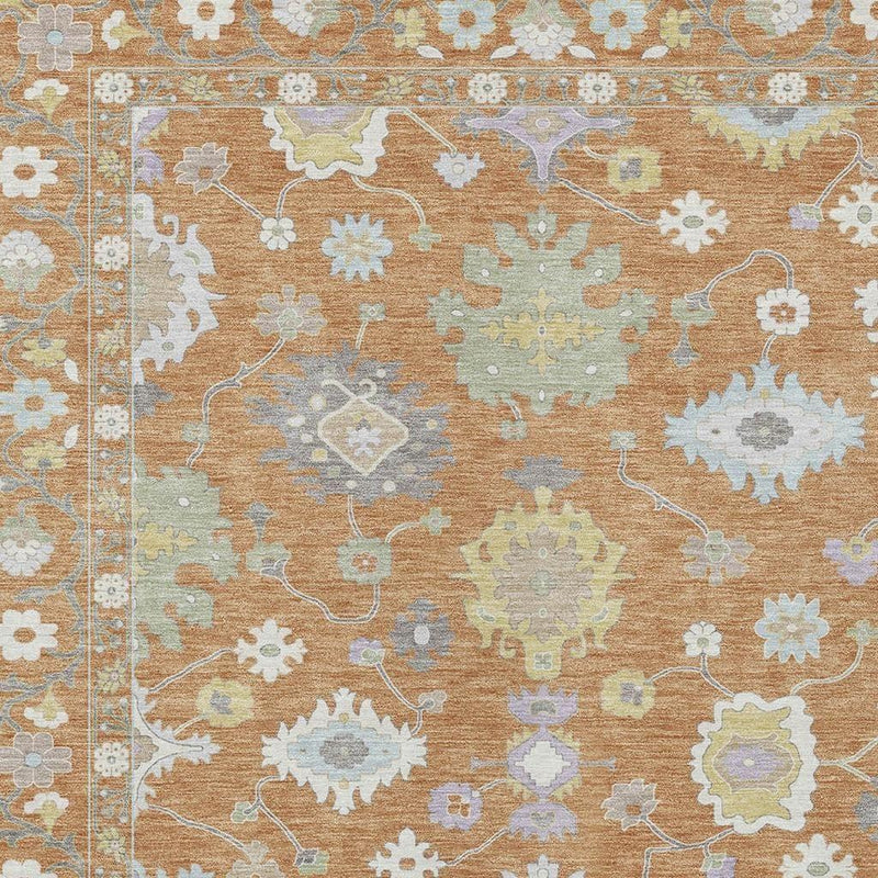Indoor/outdoor area rug close-up, copper ground with light blue floral scrollwork