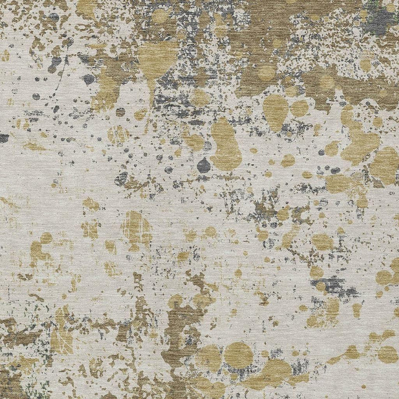 Ivory abstract rug close-up with tan, olive, gray, and dark speckled marks