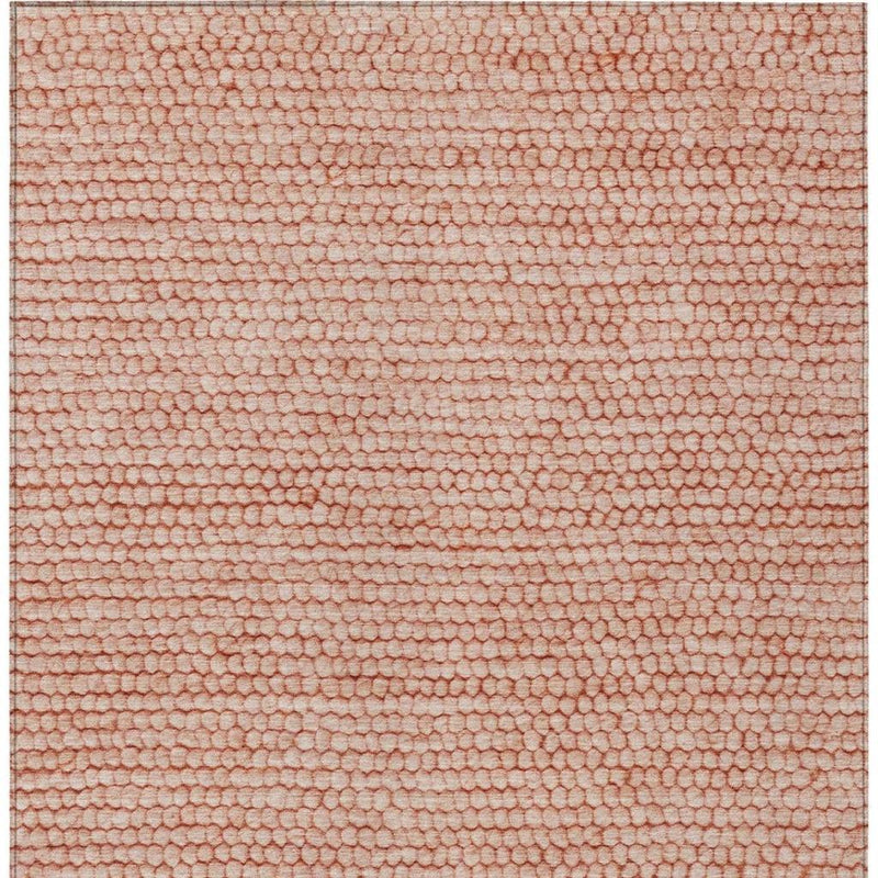Orange and salmon woven-looking area rug with dense pebble texture