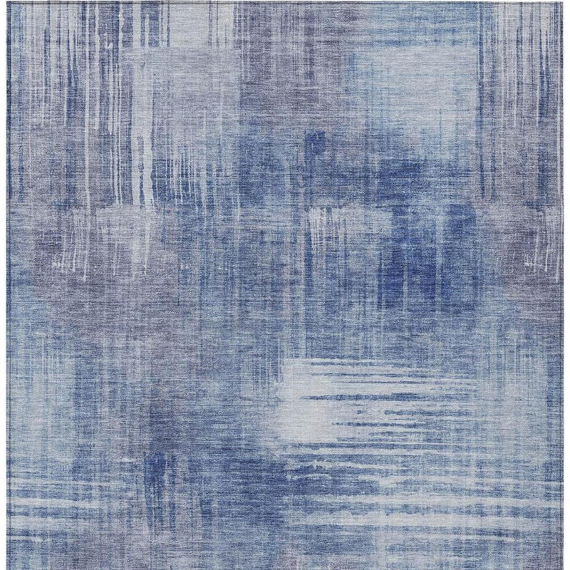 Blue abstract area rug with layered distressed blocks and brush marks