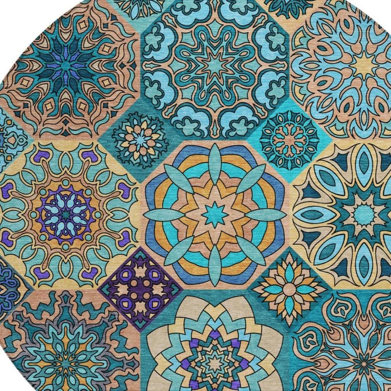 Round area rug close-up with teal and beige floral medallion patchwork motifs