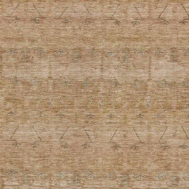 Tan rug surface with worn pattern lines and speckled texture