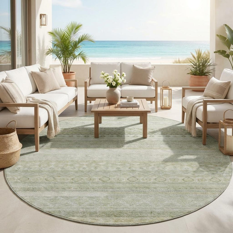 Round striped area rug on indoor floor in light green with beige banded design