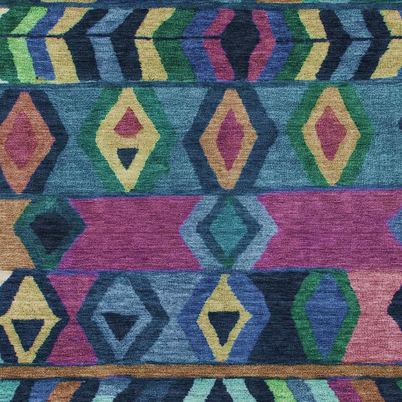 Close-up of multicolor tribal geometric area rug with blue, green, purple and tan blocks