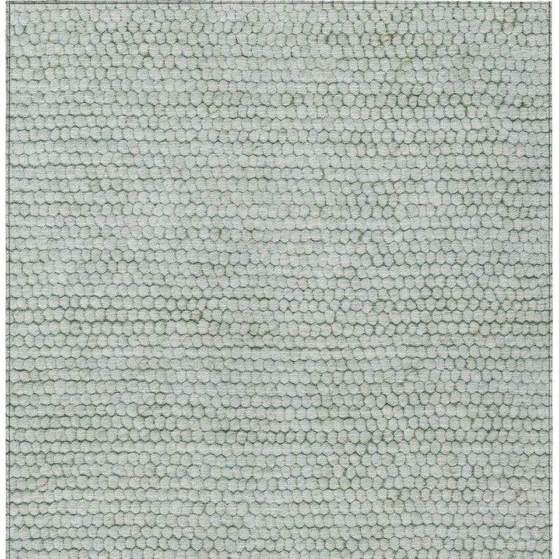 Textured green and blue area rug with dense pebble-like surface pattern
