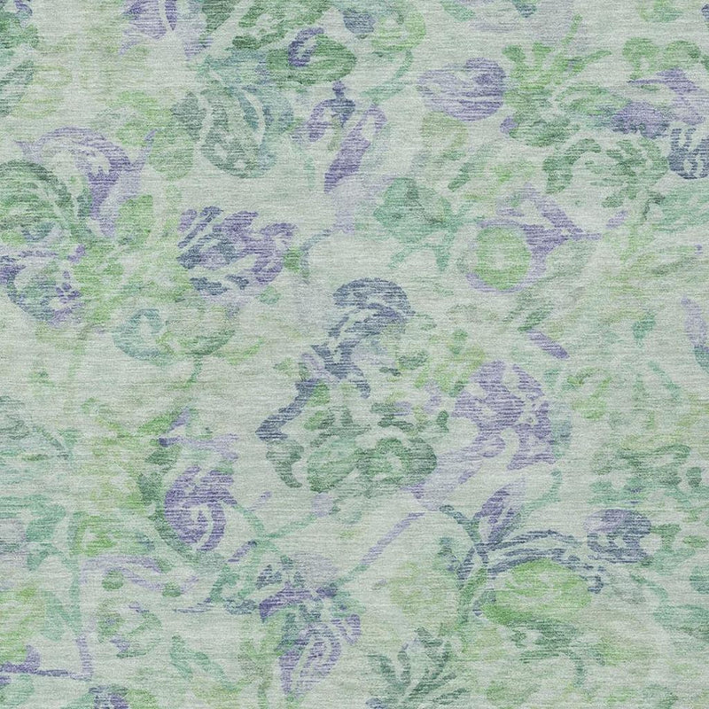Floral area rug pattern detail with mint green and blue-violet motifs on a light base