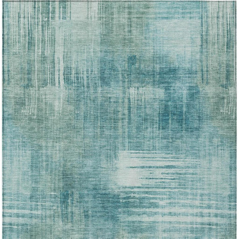 Teal blue abstract area rug close-up with layered brushstroke line pattern