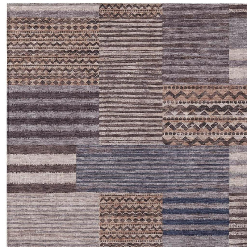 Patchwork area rug with horizontal stripes and geometric motifs in gray and brown