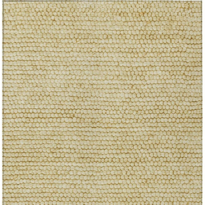 Close-up of gold and wheat area rug texture, dense loop pile with subtle speckled pattern.