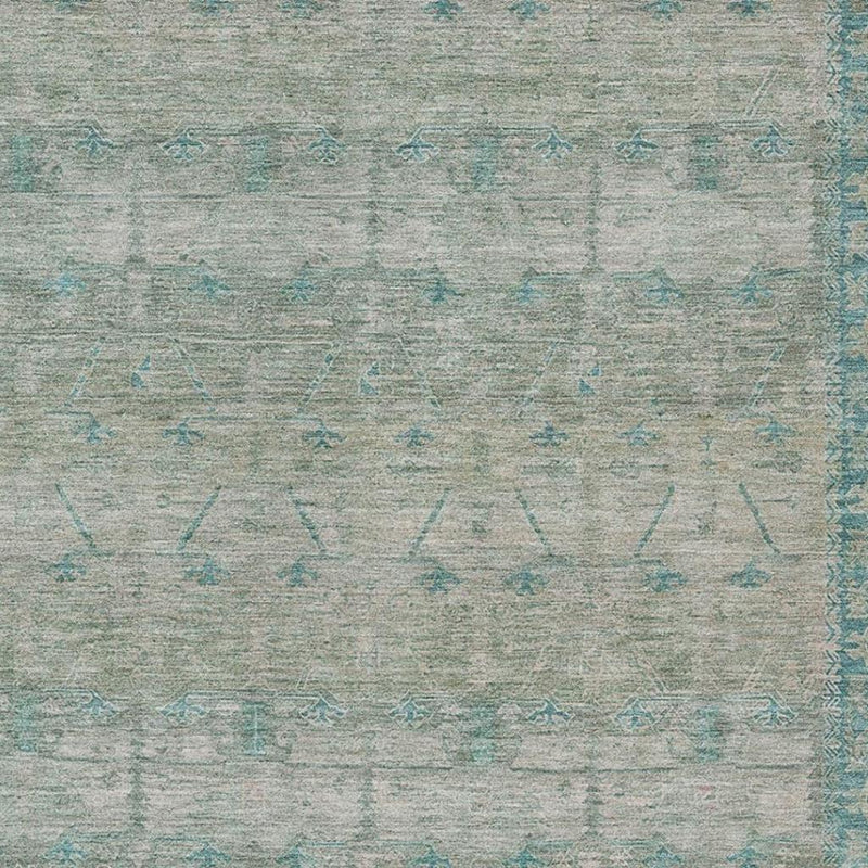 Teal blue tribal motifs on pewter ground area rug, close texture