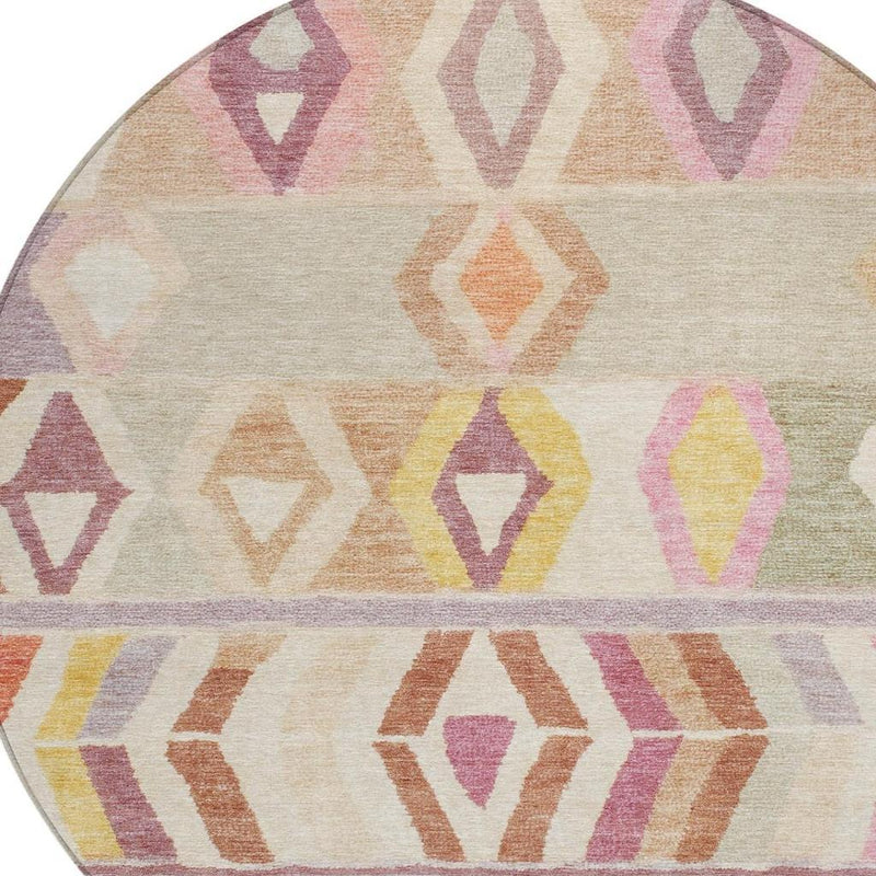 Round area rug close-up: cream background with pink, yellow, purple, brown diamond pattern