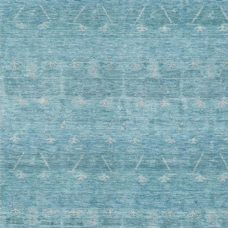 Close-up of blue and teal distressed tribal area rug pattern