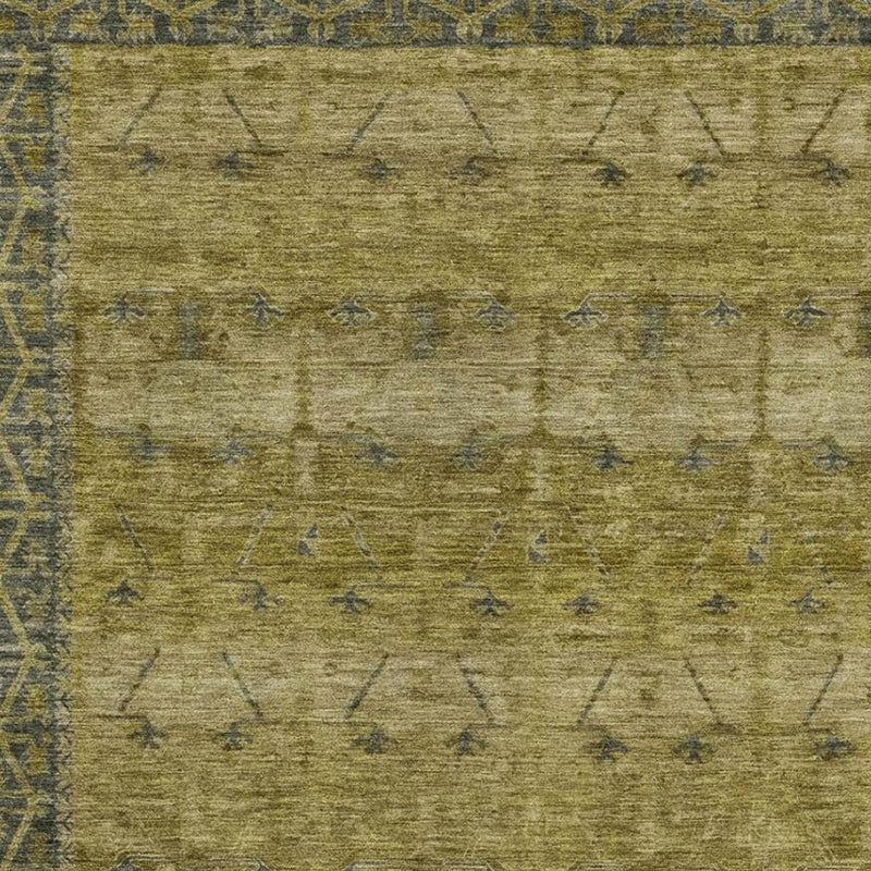 Olive area rug close-up with faded diamond and line tribal pattern in blue