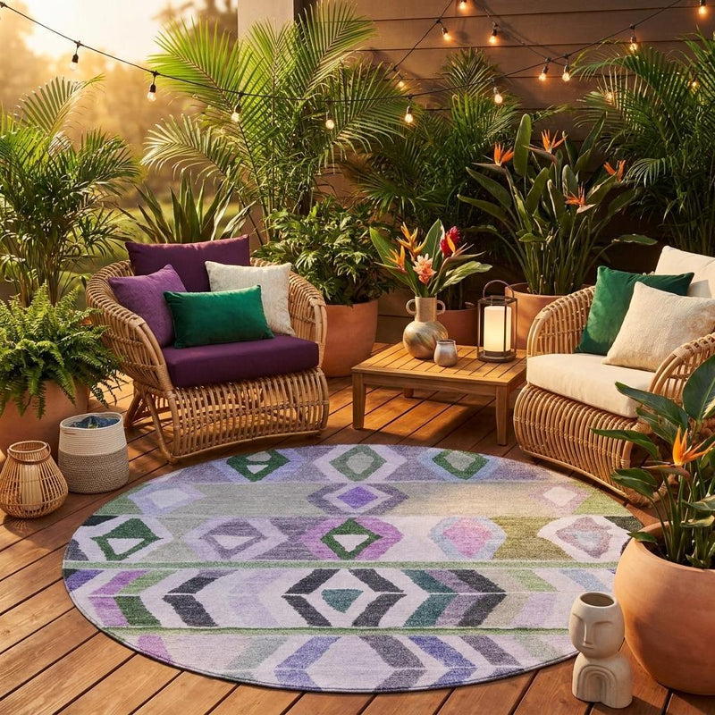 Round tribal area rug outdoors on wood deck with geometric pattern in lavender, green, and gray.