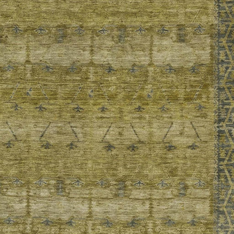 Close-up tribal area rug texture in olive with faded blue geometric lines