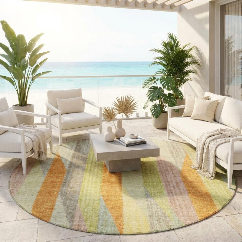 Round multicolor striped area rug displayed on the floor with vertical gold, green, and orange stripes.