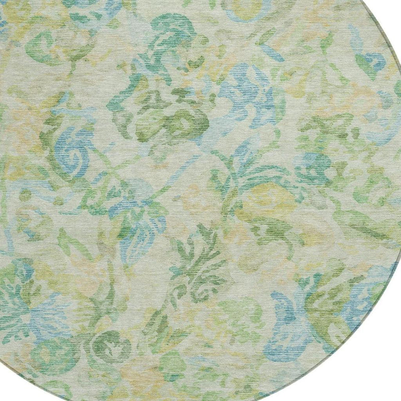Close-up of round rug surface with cream base and blue-green floral pattern