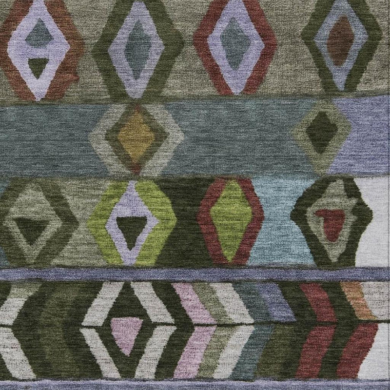 Close-up of tribal area rug pattern with multicolor diamond motifs on green