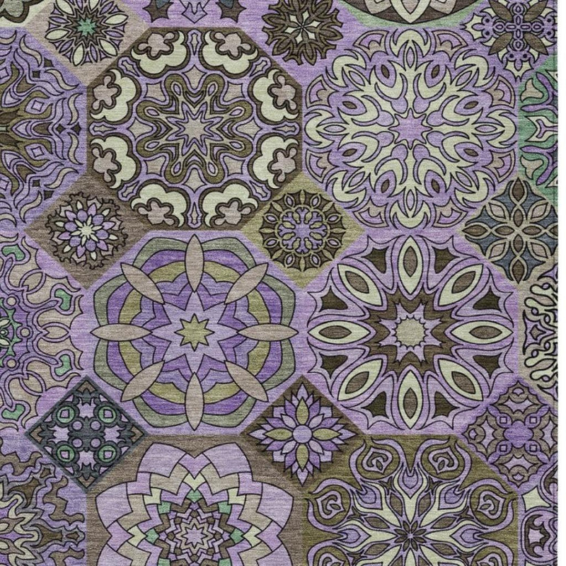 Close-up of patchwork area rug with purple rosette, star, and vine motifs
