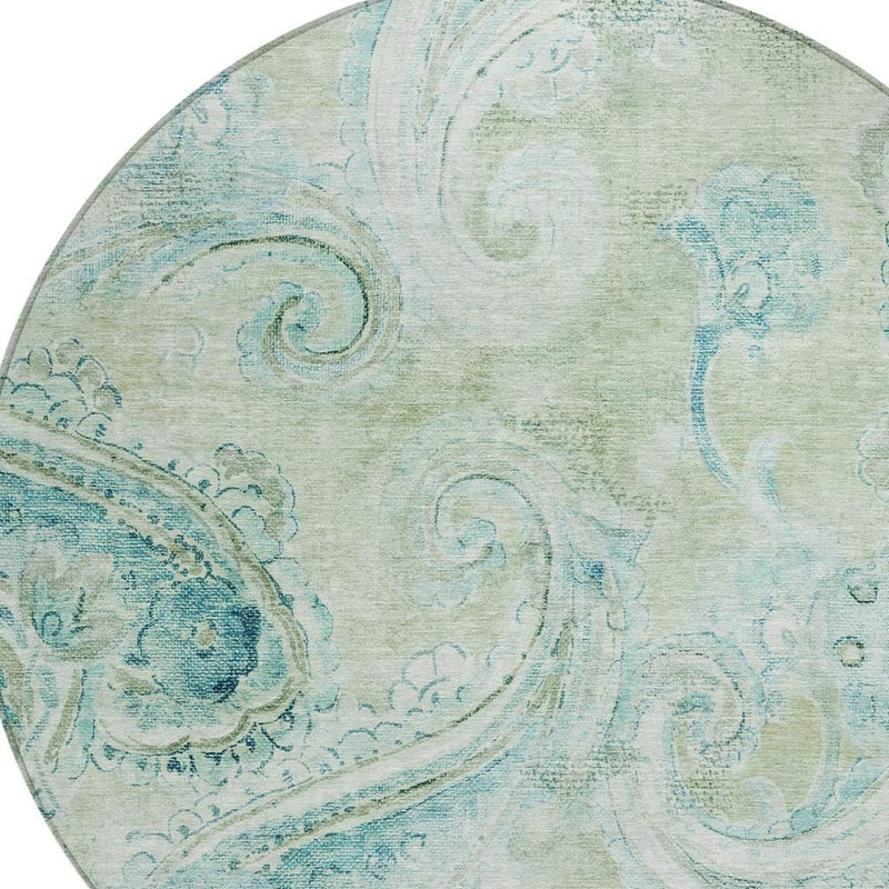 Paisley pattern close-up on round rug in sage green with blue accents