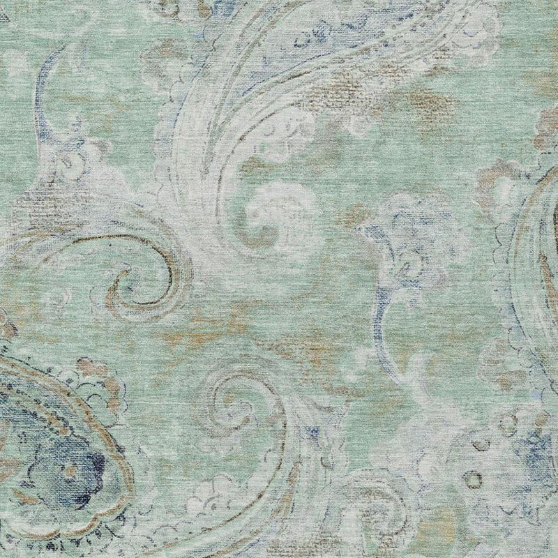 Aqua and teal paisley area rug with faded ornamental swirl design, textured finish