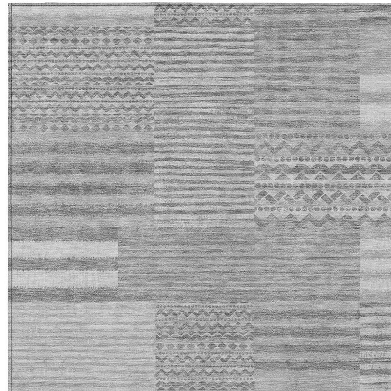 Silver and gray patchwork area rug with bordered geometric stripe bands