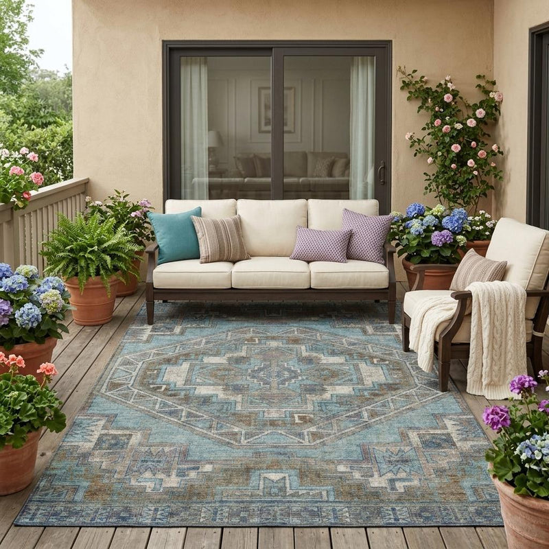 Teal blue and gray southwestern area rug with geometric pattern on a patio