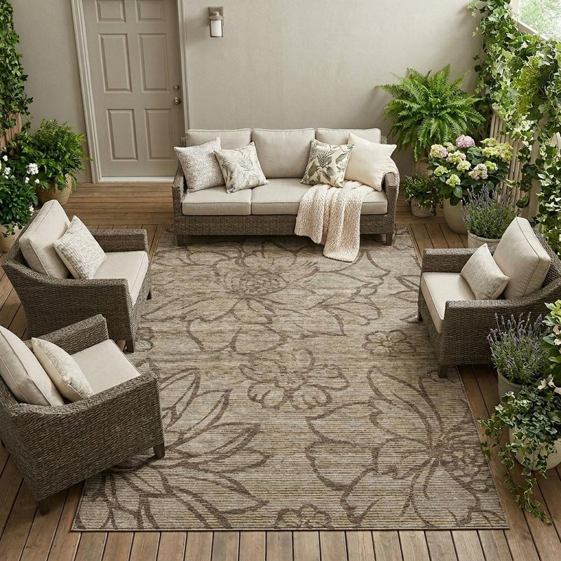 Beige floral indoor/outdoor area rug laid out in an outdoor living space