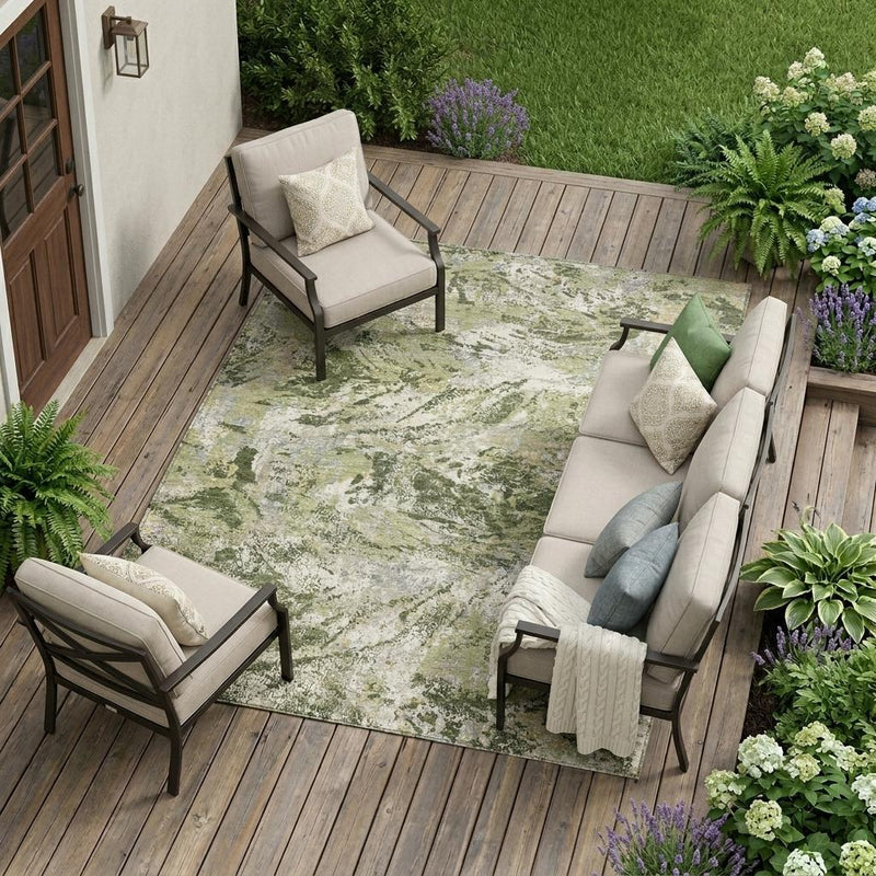 Indoor/outdoor area rug with olive green and cream abstract wash pattern